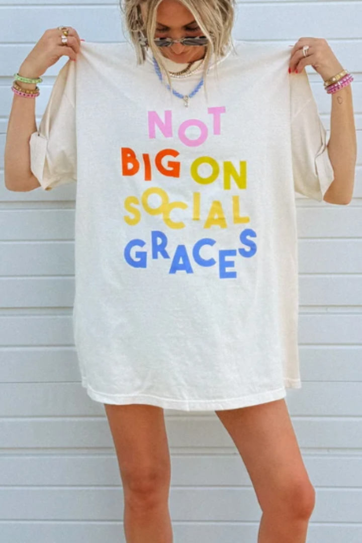 Oversized ivory graphic tee with colorful multicolor 'Not Big On Social Graces' text print