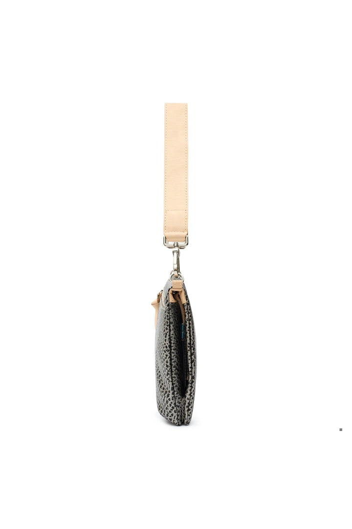 Side profile view of Consuela Tommy Metro Crossbody with leopard print and natural leather strap