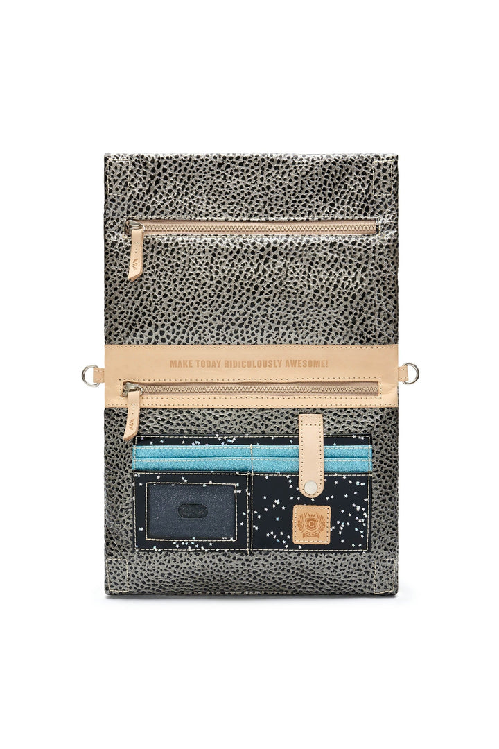 Interior view of Consuela Tommy Metro Crossbody showing card slots, zip pockets, and motivational phrase