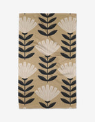 Tan kitchen tea towel with cream floral and black leaf Scandinavian folk pattern