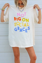 Oversized ivory graphic tee with colorful multicolor 'Not Big On Social Graces' text print