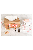 Happy Everything wooden tissue box with XOXO attachment surrounded by lipstick and tissues on marble surface