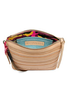 Open Consuela Downtown Crossbody Amina bag showing quilted tan exterior and colorful camo lining