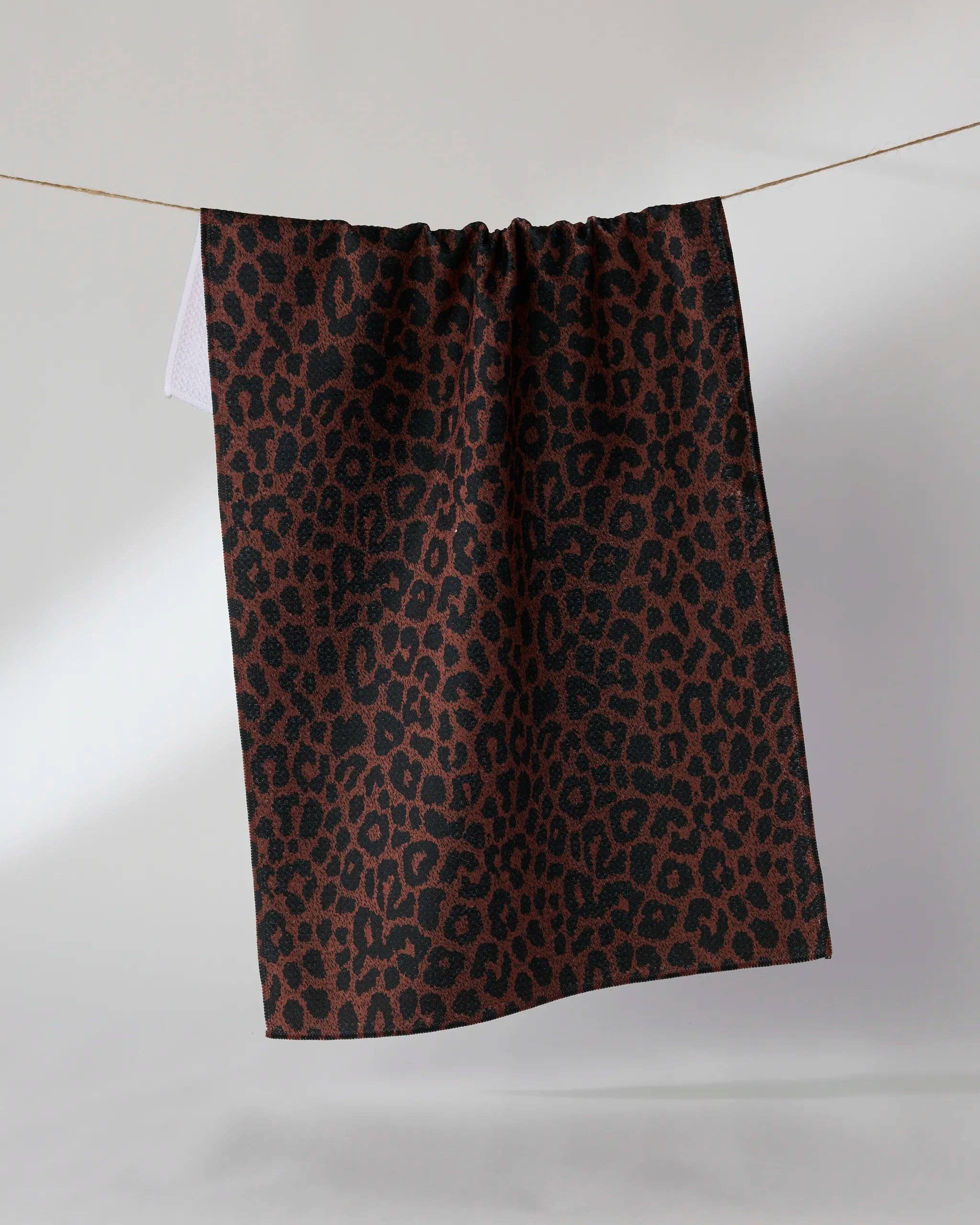 Brown and black leopard print kitchen tea towel hanging on a clothesline